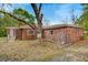 A brick home sits on a lot with mature trees and has a fenced yard at 1150 Tinsley Nw Dr, Conyers, GA 30012