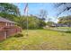 Expansive front yard featuring a lush green lawn and mature trees, perfect for outdoor activities at 1150 Tinsley Nw Dr, Conyers, GA 30012