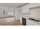 Bright kitchen with white cabinets, granite countertops, and stainless steel dishwasher at 1150 Tinsley Nw Dr, Conyers, GA 30012
