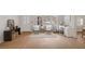 Inviting living room with wood floors, console table, front door access, and a dedicated office space at 1150 Tinsley Nw Dr, Conyers, GA 30012