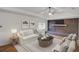 Cozy living room with brick fireplace, ample seating, and natural light, creating a welcoming atmosphere at 1150 Tinsley Nw Dr, Conyers, GA 30012