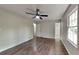 Spacious bedroom featuring wood floors, a ceiling fan, and a large window for natural light at 130 Fairview Dr, Stockbridge, GA 30281