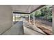 Covered carport area with concrete flooring and view to long driveway and backyard at 130 Fairview Dr, Stockbridge, GA 30281