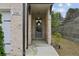 Inviting front entrance with green door, brick facade and a well-maintained landscaped area at 2310 Portrush Se Way, Atlanta, GA 30339