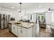 Open-concept kitchen with an island that has barstools and stainless steel appliances at 2310 Portrush Se Way, Atlanta, GA 30339