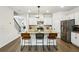 Modern kitchen featuring white cabinets, stainless steel appliances, and an island with bar seating at 2310 Portrush Se Way, Atlanta, GA 30339