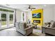 Bright living room featuring modern furnishings, a fireplace, and access to the backyard through glass doors at 2310 Portrush Se Way, Atlanta, GA 30339