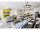 Open living space flows into a dining area and kitchen with stainless steel appliances and white cabinets at 2310 Portrush Se Way, Atlanta, GA 30339