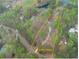Aerial view of a home on a large 2.03+/- acre lot surrounded by trees and a lake nearby at 240 Wrights Mill Way, Canton, GA 30115