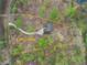 Aerial view of a home on a large 2.03+/- acre lot surrounded by trees at 240 Wrights Mill Way, Canton, GA 30115