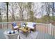 Entertain on the grey back deck with seating, throw pillows, and stylish outdoor furniture at 240 Wrights Mill Way, Canton, GA 30115