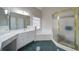 Bathroom with tub, shower, green tiled floors, and dual sinks at 240 Wrights Mill Way, Canton, GA 30115