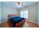 Bedroom with hardwood floors, a ceiling fan, and a large window at 240 Wrights Mill Way, Canton, GA 30115