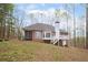 Back of the brick home featuring a porch, a screened-in sunroom, and an expansive lot at 240 Wrights Mill Way, Canton, GA 30115