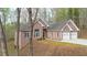 Charming brick home with attached two-car garage and mature trees at 240 Wrights Mill Way, Canton, GA 30115