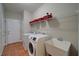 Functional laundry room with washer, dryer, sink and storage shelves at 240 Wrights Mill Way, Canton, GA 30115