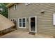 Back patio with door to inside provides outdoor access and entertainment space at 3420 Sweetbriar Ln, Powder Springs, GA 30127