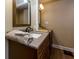 Bathroom with granite countertops, modern sink fixtures, and wood cabinets for storage, with a wood floor at 3420 Sweetbriar Ln, Powder Springs, GA 30127