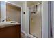 Bathroom showcasing a shower with glass doors and a vanity with granite countertops and wood cabinets at 3420 Sweetbriar Ln, Powder Springs, GA 30127