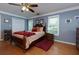 Cozy bedroom with hardwood floors, a ceiling fan, and abundant natural light from the windows at 3420 Sweetbriar Ln, Powder Springs, GA 30127