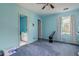 Bright bedroom with blue walls, en-suite bathroom, and window with natural light at 3420 Sweetbriar Ln, Powder Springs, GA 30127