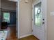 Foyer leading to a bedroom, showcasing a decorative glass front door and neutral wall paint at 3420 Sweetbriar Ln, Powder Springs, GA 30127
