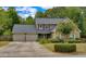 Charming home featuring a two-car garage, well-maintained landscaping, and a mix of stone and siding exterior at 3420 Sweetbriar Ln, Powder Springs, GA 30127