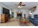 Comfortable living room with a fireplace, tile floors, and a ceiling fan, creating a warm ambiance at 3420 Sweetbriar Ln, Powder Springs, GA 30127