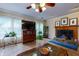 Cozy living room with fireplace, TV, and tile floors offers a relaxing space at 3420 Sweetbriar Ln, Powder Springs, GA 30127