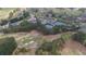 Aerial view of a community with a golf course, tennis courts, pool, clubhouse, and plenty of parking at 5224 Brendlynn Dr, Suwanee, GA 30024