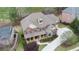 Aerial view of beautiful brick home with covered front porch, manicured lawn, and extended driveway at 5224 Brendlynn Dr, Suwanee, GA 30024