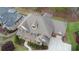Brick home aerial view featuring screened porch, lush backyard and manicured lawn at 5224 Brendlynn Dr, Suwanee, GA 30024