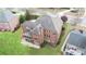 Aerial view of brick home featuring screened in porch, patio, lush lawn, and pristine landscaping at 5224 Brendlynn Dr, Suwanee, GA 30024
