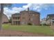 Large brick home with a manicured backyard and screened porch overlooking landscaped lawn at 5224 Brendlynn Dr, Suwanee, GA 30024