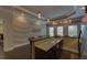 Elegant bar area with granite counters, cocktail sign, chevron wall, and pendant lighting at 5224 Brendlynn Dr, Suwanee, GA 30024