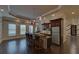 Entertainment area features a wet bar with counter seating, dark cabinets, and hardwood floors at 5224 Brendlynn Dr, Suwanee, GA 30024