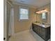 Bathroom featuring granite counters, a dark wood vanity, and a shower with curtain at 5224 Brendlynn Dr, Suwanee, GA 30024