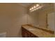 Bathroom featuring a long granite countertop, warm lighting, and ample cabinet space at 5224 Brendlynn Dr, Suwanee, GA 30024