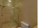 Bright bathroom featuring a glass shower and white toilet in a clean space at 5224 Brendlynn Dr, Suwanee, GA 30024