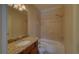 Tiled bathroom features a tub and shower combination, granite countertops, and neutral color palette at 5224 Brendlynn Dr, Suwanee, GA 30024