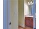 Bathroom view featuring granite counters and dark wood cabinets at 5224 Brendlynn Dr, Suwanee, GA 30024