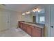 Spacious bathroom featuring double sinks with granite countertops and a large mirror at 5224 Brendlynn Dr, Suwanee, GA 30024