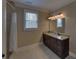 Bathroom featuring a granite countertop, vanity, window, and shower with white curtain at 5224 Brendlynn Dr, Suwanee, GA 30024