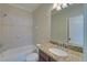 Bathroom showcasing a marble vanity and a white tiled shower-tub combo at 5224 Brendlynn Dr, Suwanee, GA 30024
