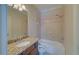 Bright bathroom features granite counters, tiled shower and tub at 5224 Brendlynn Dr, Suwanee, GA 30024