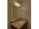 Granite countertop vanity with sink and stylish lighting in a well-maintained bathroom at 5224 Brendlynn Dr, Suwanee, GA 30024