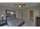 Neutral bedroom with an ensuite, features a bed, dresser, nightstand, and unique wallpaper at 5224 Brendlynn Dr, Suwanee, GA 30024
