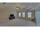 Large bedroom boasting a tray ceiling, neutral walls, and ample natural light at 5224 Brendlynn Dr, Suwanee, GA 30024