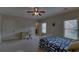 Well-lit bedroom with carpet, ceiling fan and a desk with an office chair at 5224 Brendlynn Dr, Suwanee, GA 30024