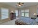 Well-lit bedroom with natural light and a classic dresser and bedside table at 5224 Brendlynn Dr, Suwanee, GA 30024